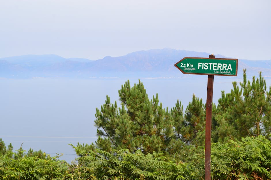 Signpost for Fisterra representing the journey to wellness