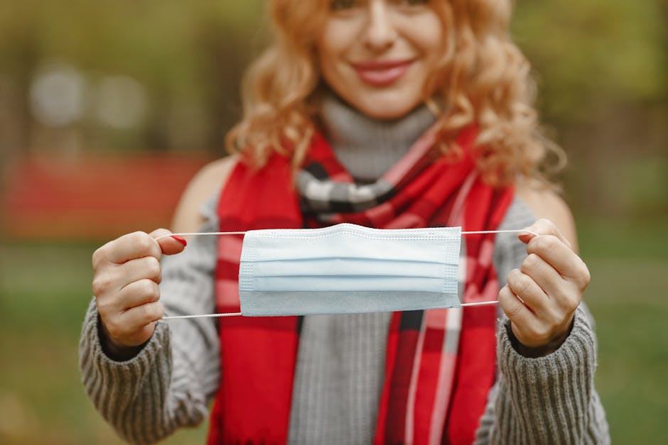 Woman holding a face mask for health protection